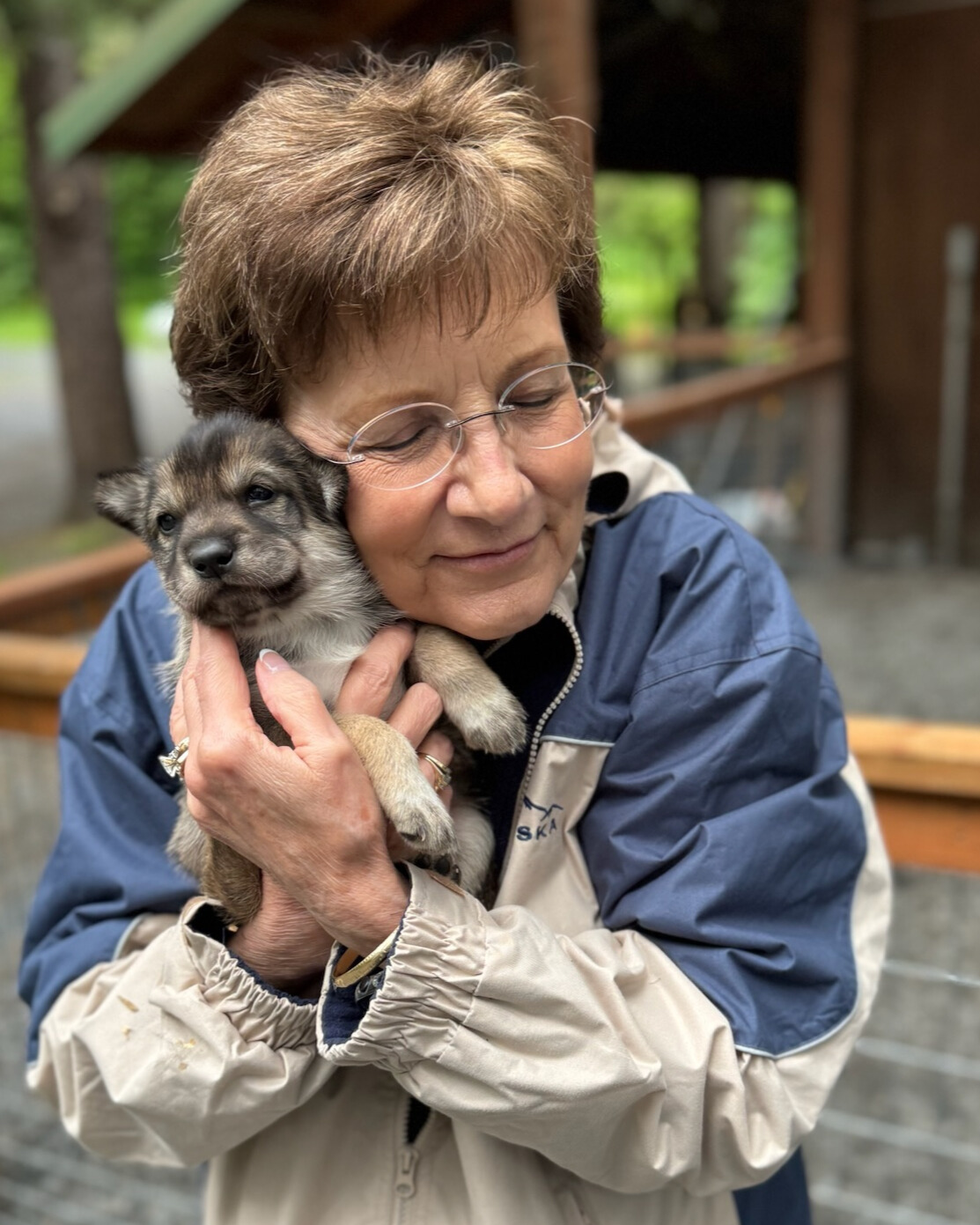 A woman pictured hugging a small puppy