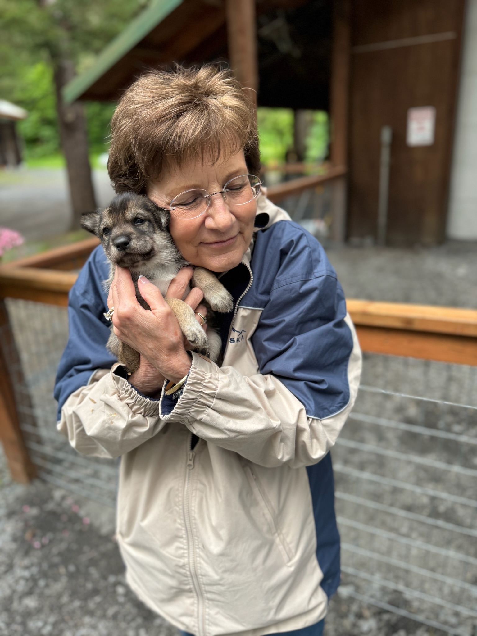 Victoria “Vicky” Searls Traylor with small puppy cuddled to her cheek
