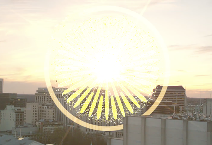 big yellow logo with sun behind