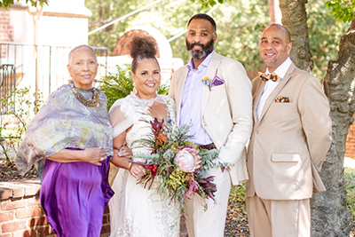 Boone (center left) and husband Eric Clay (center right) following their wedding ceremony Sept. 16, 2023. Pictured with Jean Patterson Boone, mother of the bride (left), and Raymond H. Boone Jr., brother of the bride (right). Photo credit: Samia Minnicks Photography