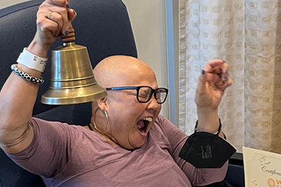 Boone rings a bell at the VCU Health Adult Outpatient Pavilion to celebrate her completion of chemotherapy on Dec. 14, 2023. Photo credit: Eric Clay