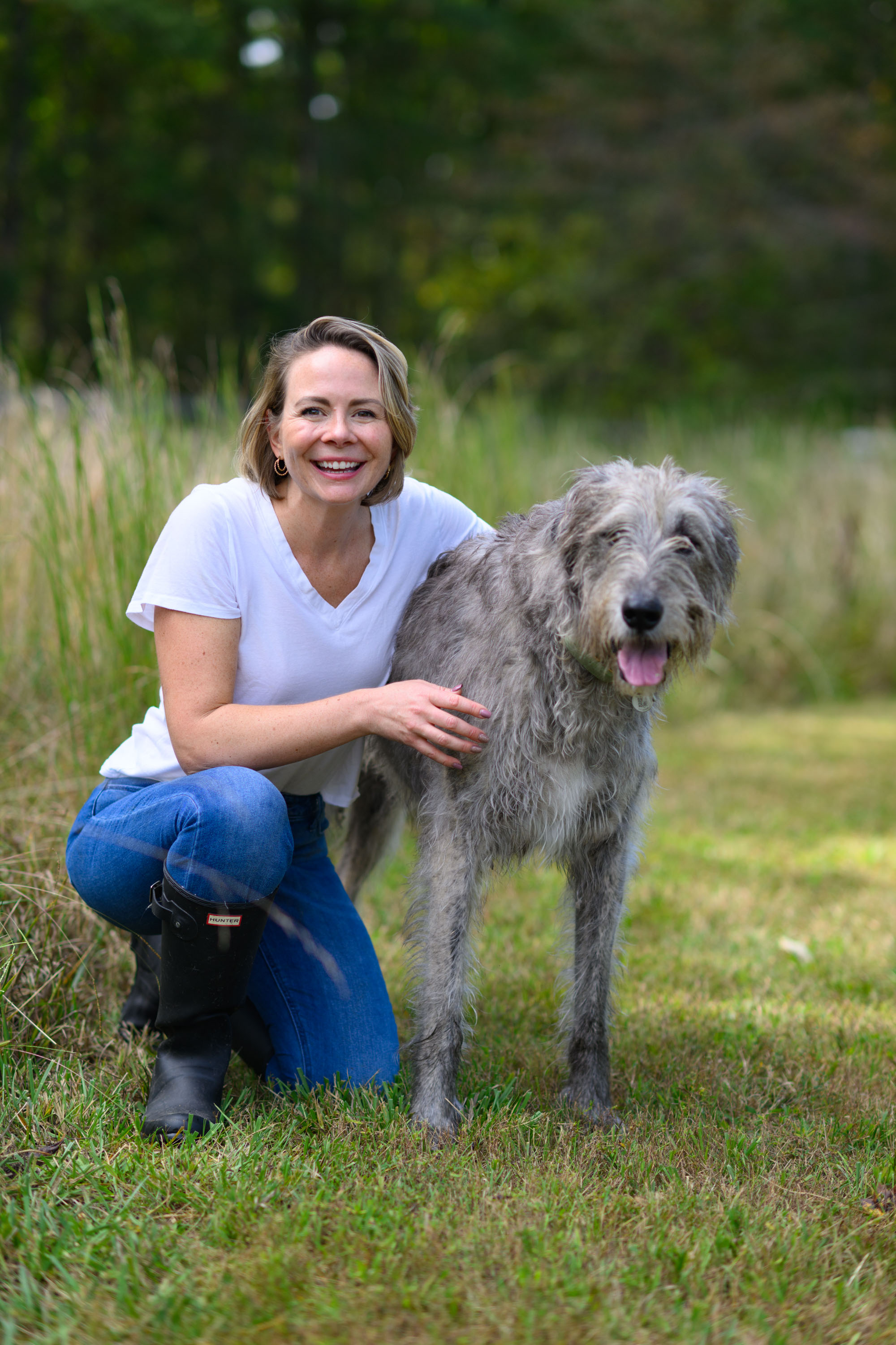 Samantha Edall pictured with her dog outdoors in grassy area