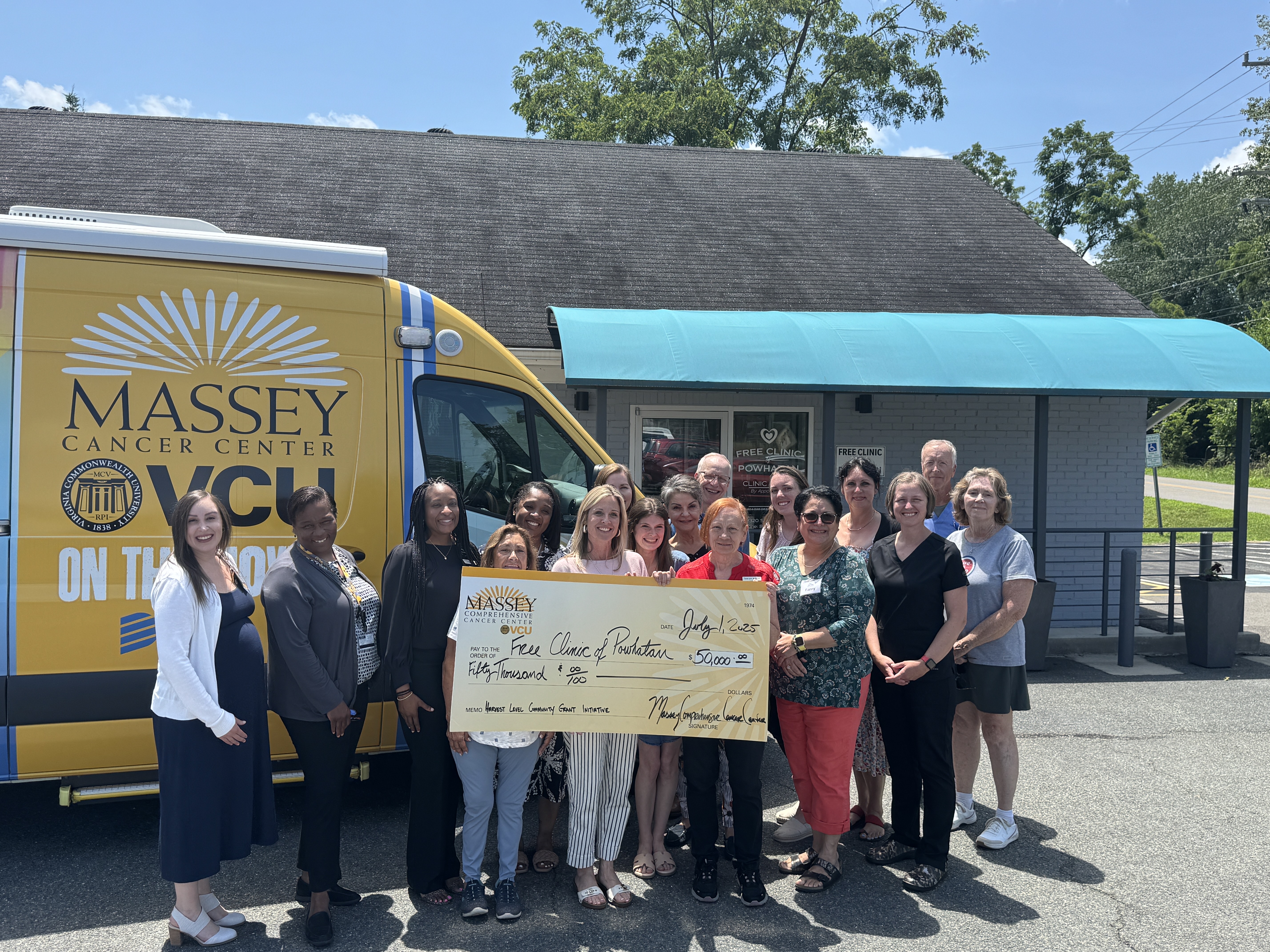 Massey Community Outreach and Engagement staff pictured with $50,000 check