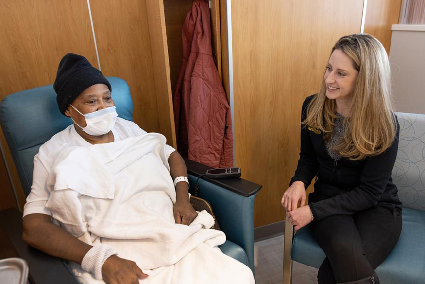 Keri Maher, D.O., checks on Pearl Thomas, Massey patient