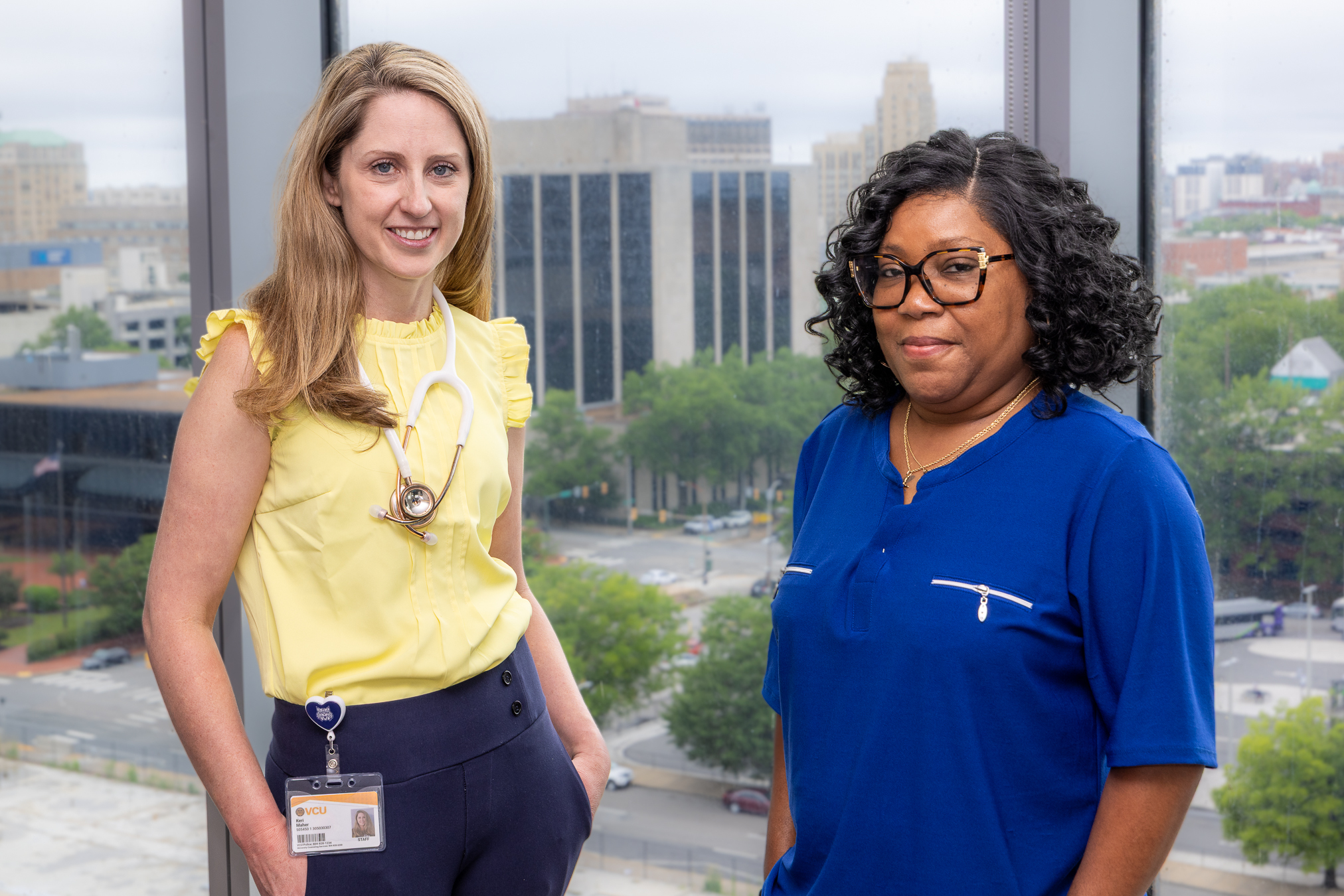 Keri Maher, D.O. (left) standing with patient and Massey Cancer Champion Mary Simmons (right).