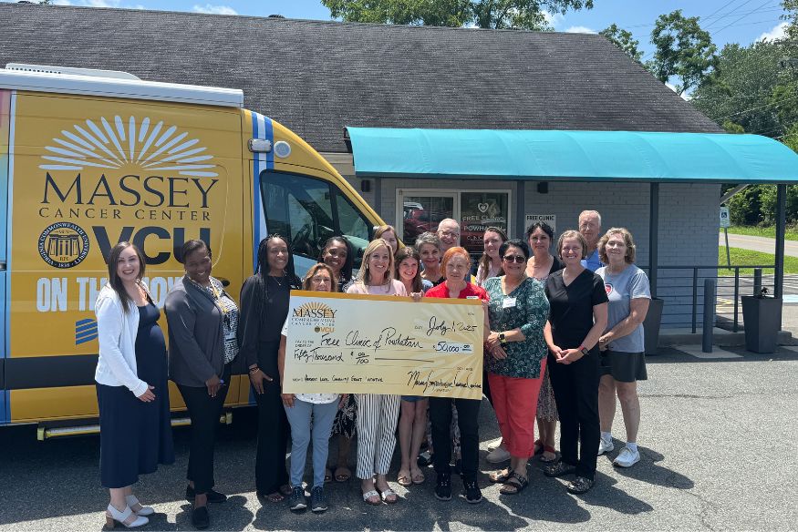 Massey Community Outreach and Engagement staff pictured with jumbo check