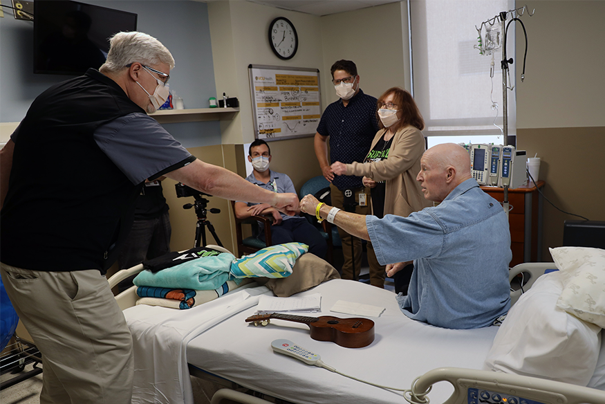 Michael Stigall fist bumping a Massey doctor after treatment
