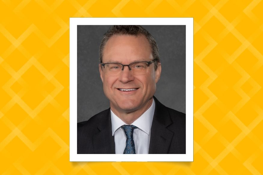 David Nalepinski headshot in frame with yellow background