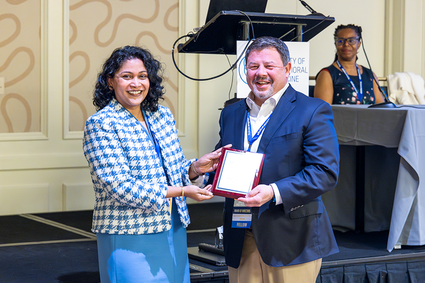 Fuemmeler (right) receiving an award at the SBM Annual Meeting