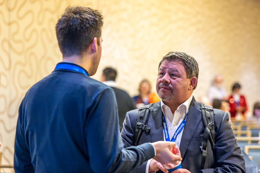 Fuemmeler speaking to an attendee at the SBM Annual Meeting