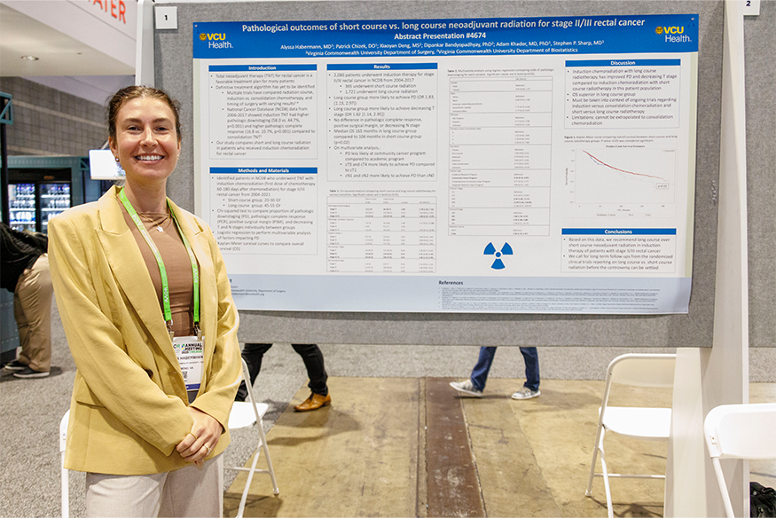 Alyssa Habermann, M.D. standing with to her research