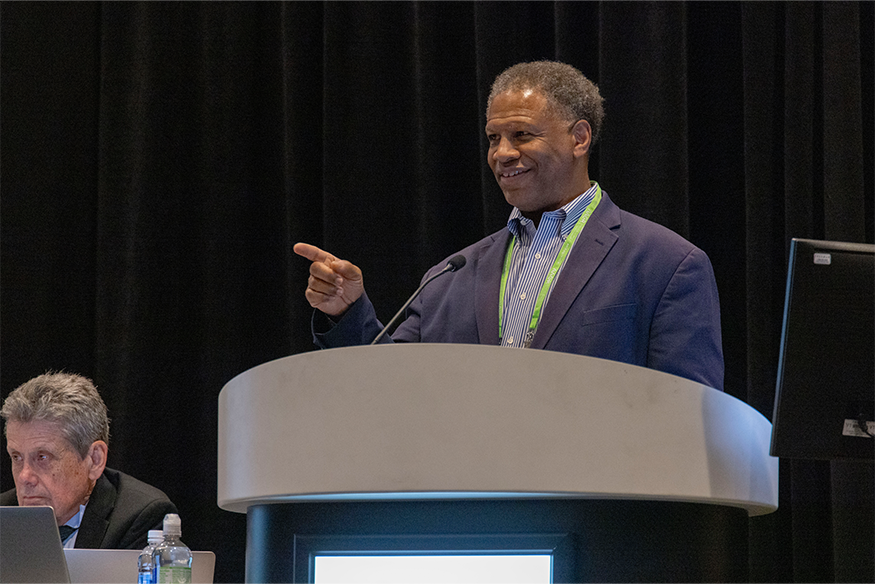 Robert Winn, MD standing at podium at AACR 2025