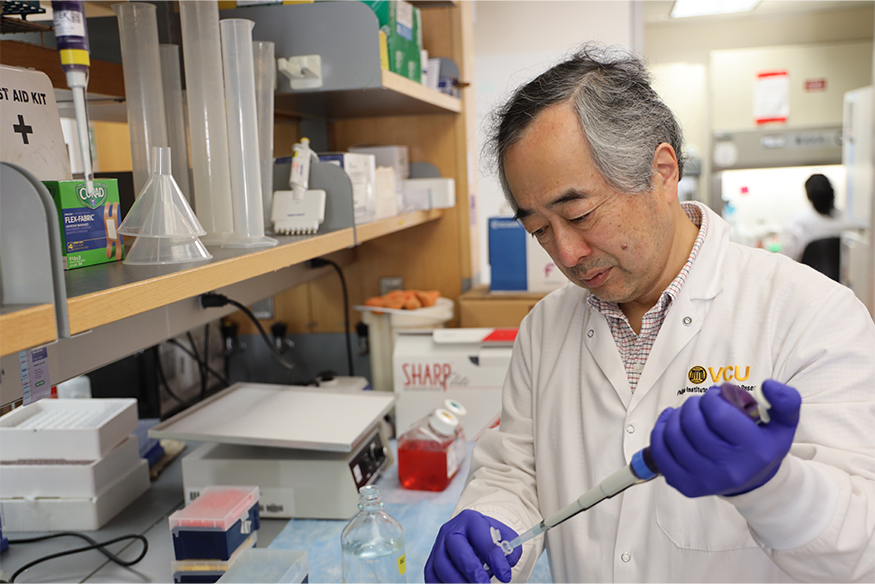 Hisashi Harada working with medical instruments for research