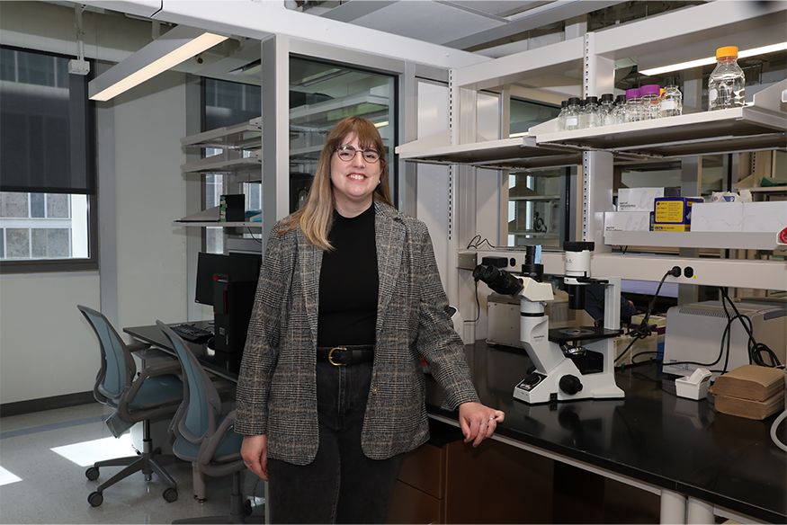 Photo of Holly Byers posed inside of research lab
