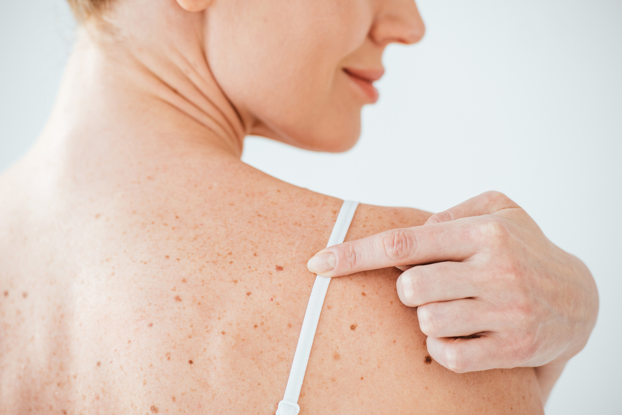 Close up of woman applying sunscreen