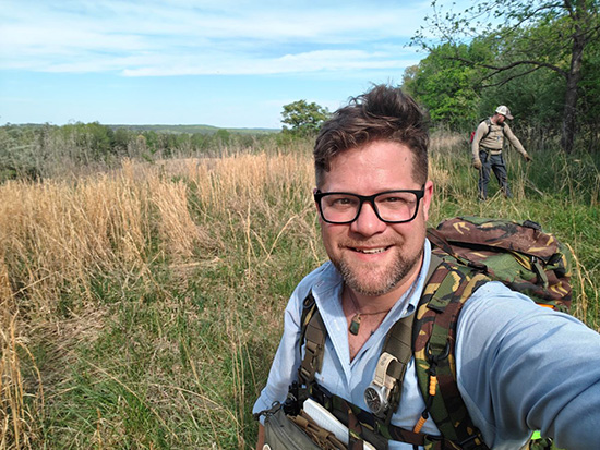 VCU Massey social media manager Keith Jones posing in the Virginia wilderness during search and rescue training