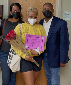 Kelsey Holmes celebrates the completion of her chemotherapy treatment with her parents by her side.