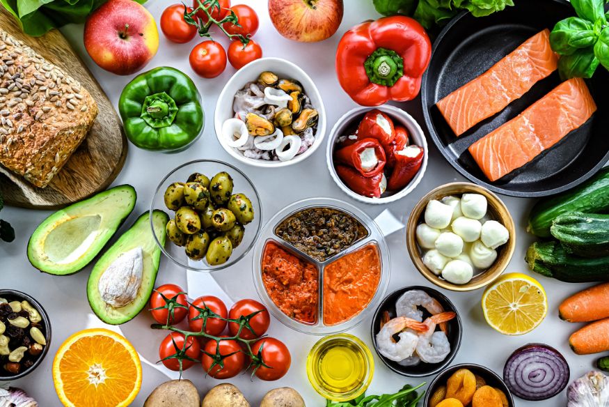 Close up table of various bright colored fruits and vegetables