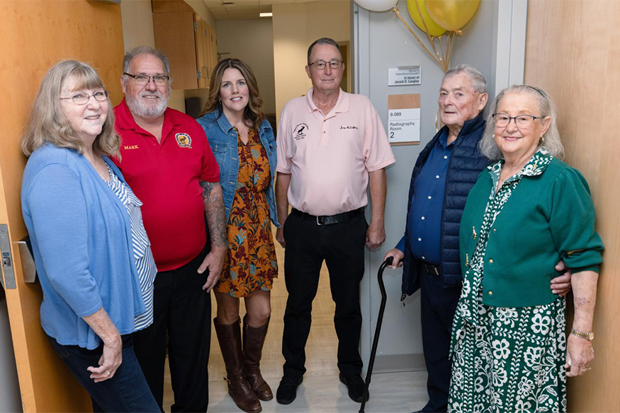 Virginia Moose Association members standing in front of the door of a space in VCU Health's Adult Outpatient Pavilion that was made possible by the Association.