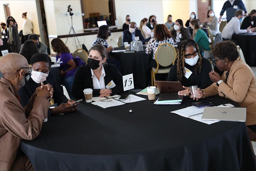 Community members and researchers discuss questions in the event’s morning mixer.